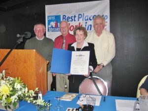 state representatives posing with chairperson after presenting with award