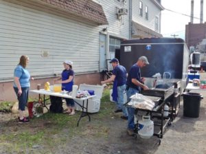 employees cooking breakfast outside