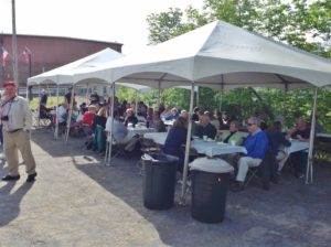 people enjoying breakfast under tent