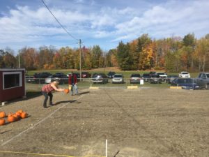 woman throwing pumpkin