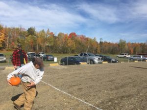 man throwing pumpkin