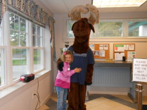 young child posing with Monty Moose