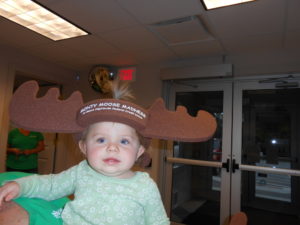 young child wearing foam antlers