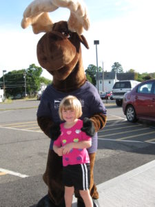 young girl posing with Monty Moose