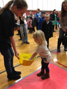 young girl choosing a prize at event