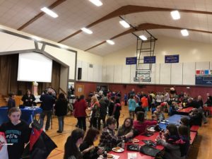 children enjoying games and food in gymnasium