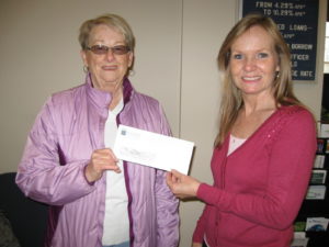 employee presenting check to member