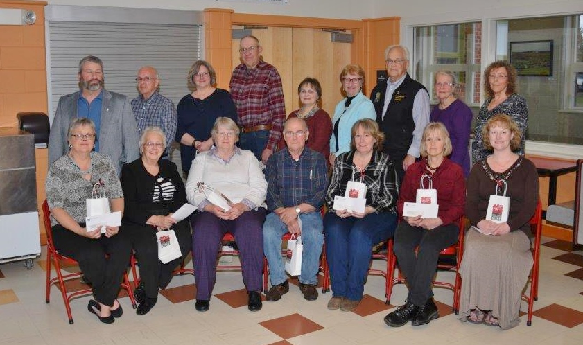 Sixteen representatives from local food cupboards pose for picture