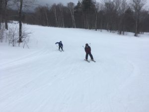 two boys skiing down mountain