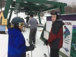 skiiers ready to get on chair lift