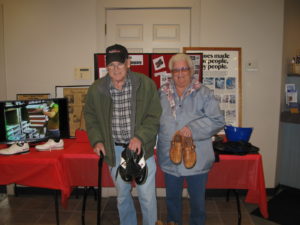 members posing in front of Dexter Shoe display