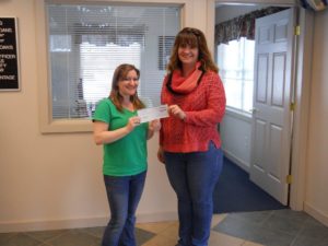 employee presenting check to member