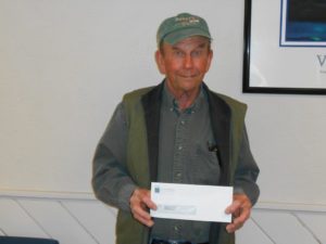 Man showing his winning check