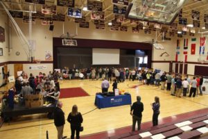 gymnasium full of students attending a financial fitness fair