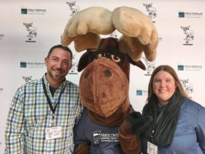 man and woman posing with Monty Moose at Moosetech