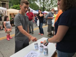 boy at festival trying a bottle flipping game