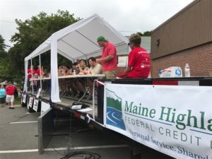 people eating hot dogs at an eating contest