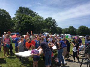 large group of people watching pie eating contest