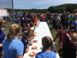 about 12 children ready to start pie eating contest