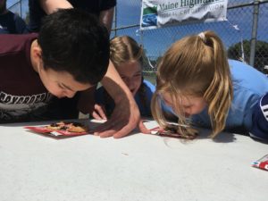 boy and girl eating pie without using their hands