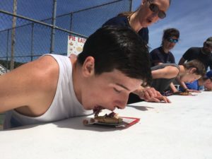 boy eating pie without using hands