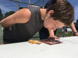 boy eating pie without using hands