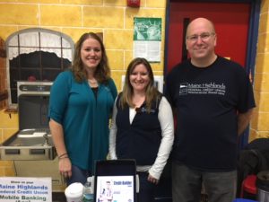 Three employees posing at vendor fair