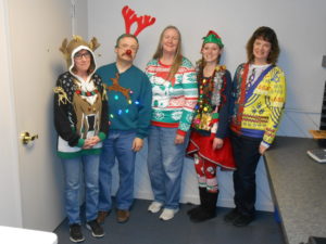 employees in ugly Christmas sweaters