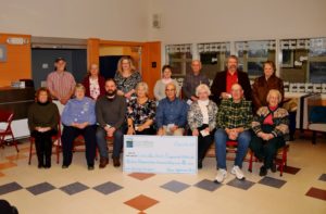 food orgainzation representatives posing for picture with large check