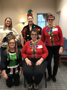 employees in ugly Christmas sweaters