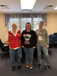 employees in ugly Christmas sweaters