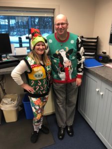 employees in ugly Christmas sweaters