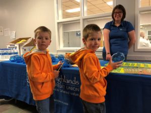 two boys looking at items on the table