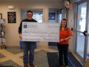 First place winner holding large check with Brownville employee