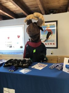 Monty Moose at table with giveaways