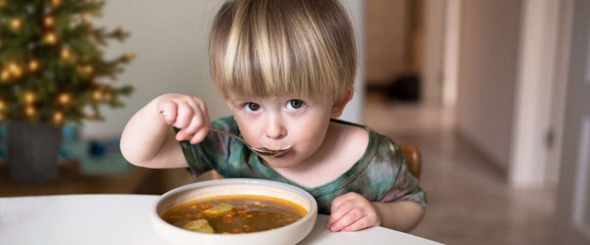 Little boy eating soup