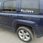 Blue Jeep Driver's Side