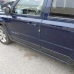Blue Jeep Driver's Side
