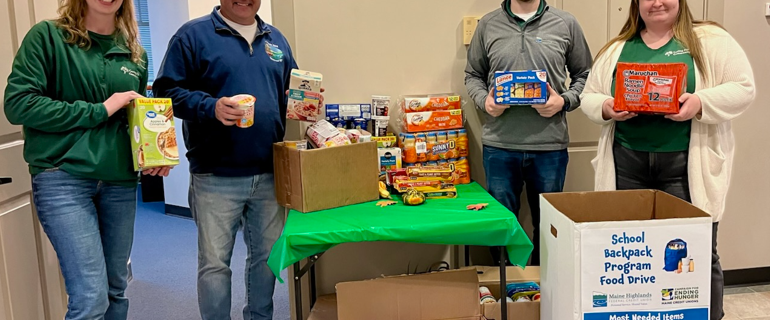 MHFCU donating food for school backpack programs